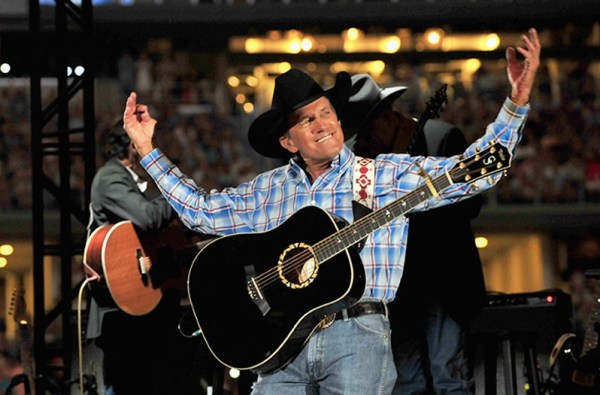George Strait onstage with guitar