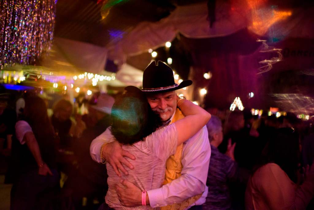 Mark Scherer, right, dances with his wife Shelley Scherer, left, at the 11th Street Cowboy Bar during the Cowboy Mardi Gras celebration in Bandera, Texas on February 15, 2020. 