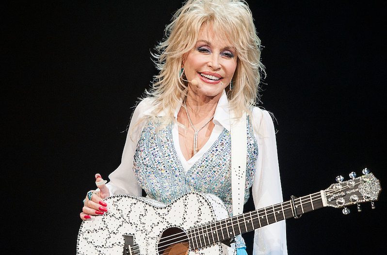 Dolly Parton Poses with guitar