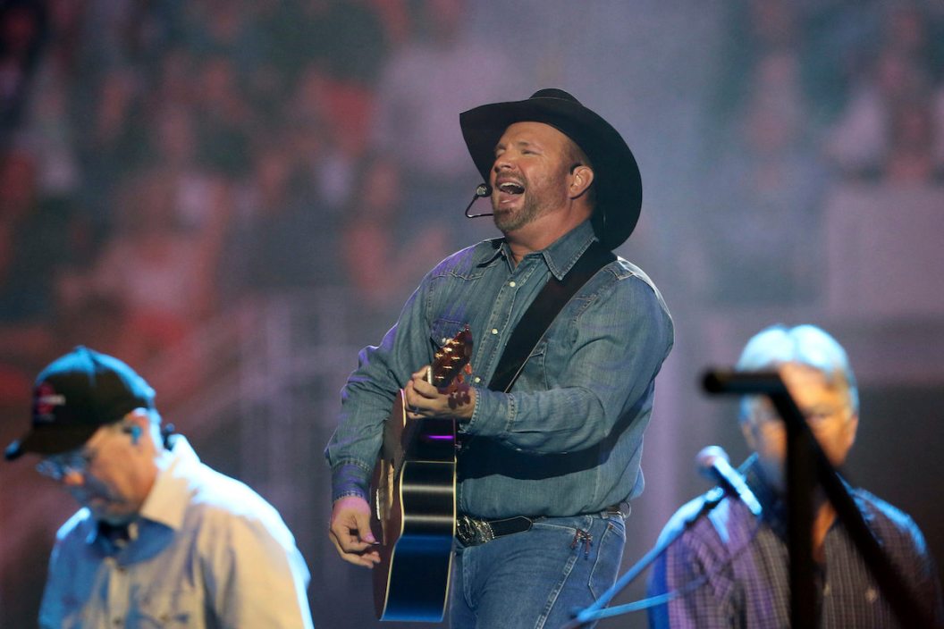 Garth Brooks performs to a packed stadium crowd.