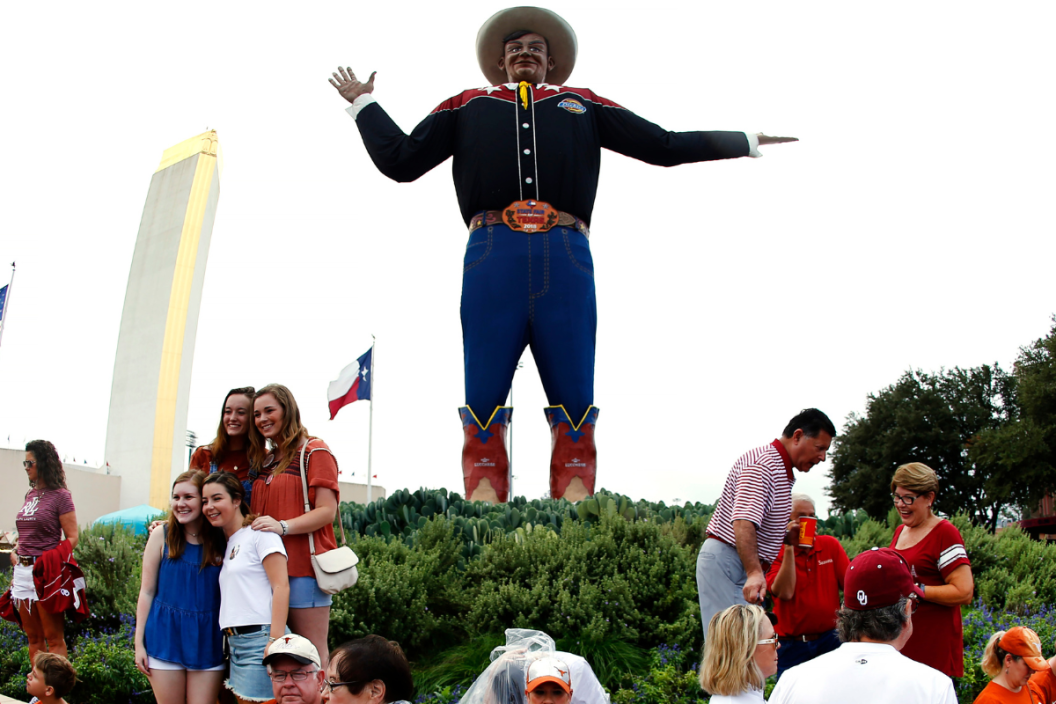 Fairgoers gather at Big Tex at the State Fair of Texas, home to the Red River Showdown football game between Texas and Oklahoma at the Cotton Bowl October 6, 2018 in Dallas, Texas.