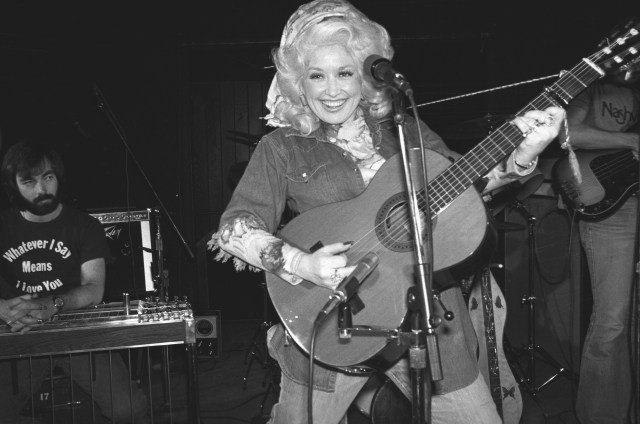 Dolly Parton onstage with guitar