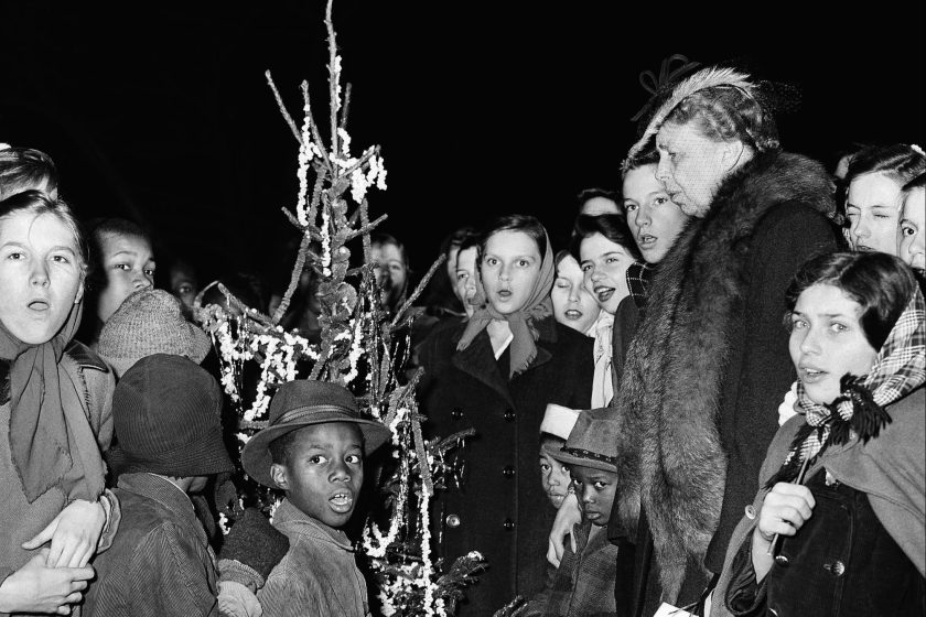 Mrs. Franklin D. Roosevelt (at the right) sings with children in a program of Christmas carols before an outdoor Christmas tree, in Washington, D.C., on Dec. 21, 1944.