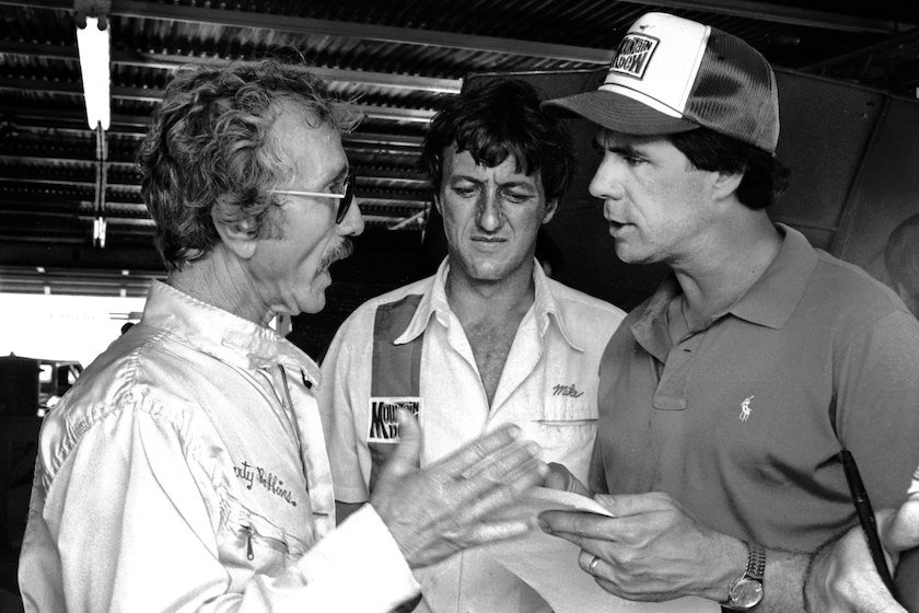 DAYTONA BEACH, FL - JULY, 1981: Darrell Waltrip, talks with fellow driver and country music singer Marty Robbins, left, during qualifying for the 1981 Firecracker 400 at the Daytona International Speedway in Daytona Beach, Florida. 