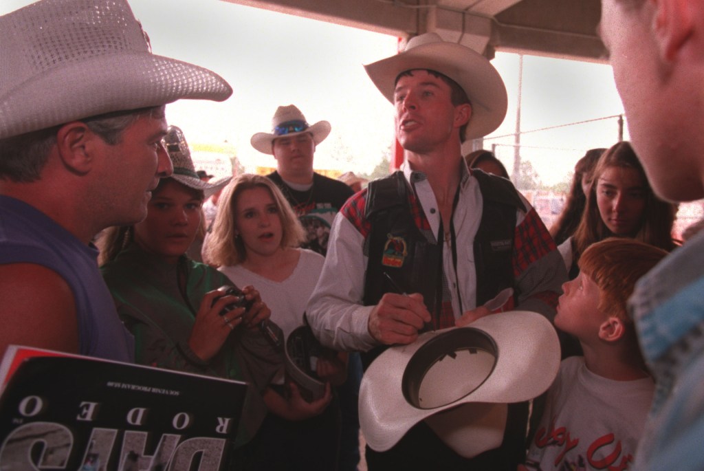 Champion bull rider Tuff Hedeman signs autographs after winning the "Daddy of "Em All" Frontier Days Rodeo in Cheyenne, Wyoming.(Photo By JOEY MCLEISTER/Star Tribune via Getty Images)