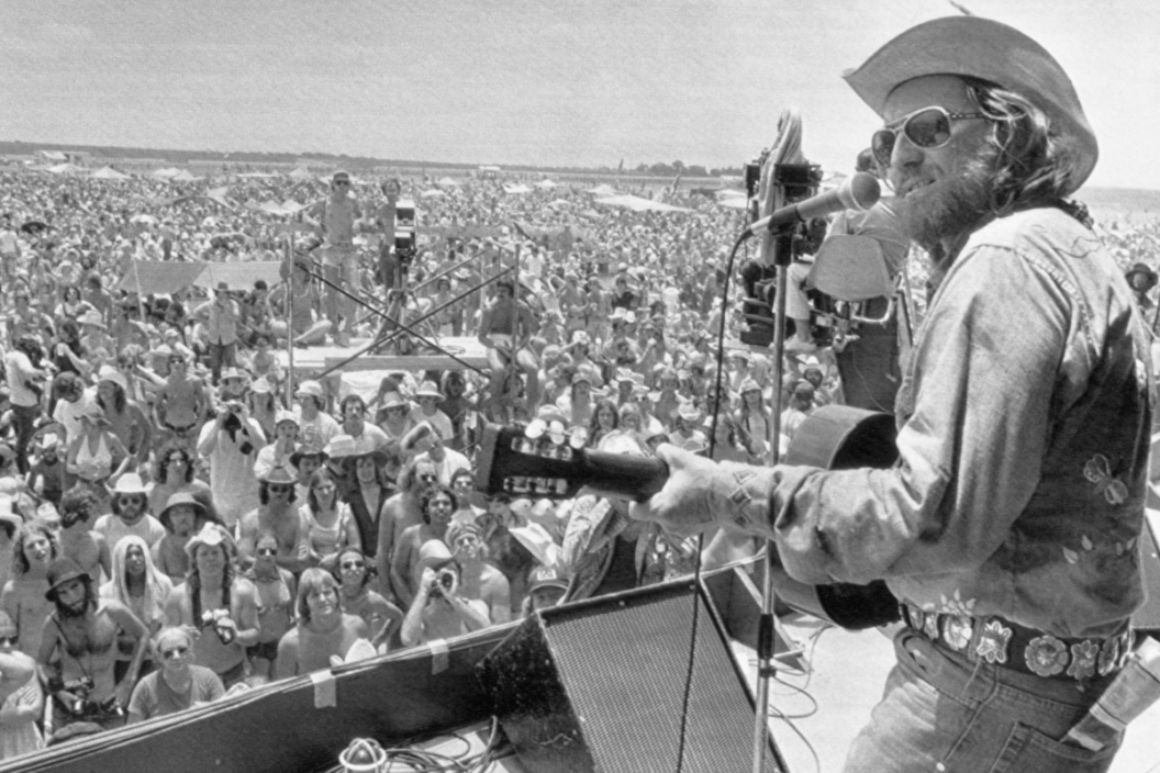 Country-Rock singer Willie Nelson thrills a young crowd 40,000 strong as he opens his 'July 4th Picnic' in College Station, Texas. Crowds of over 150,000 are expected during the three day weekend music fest.