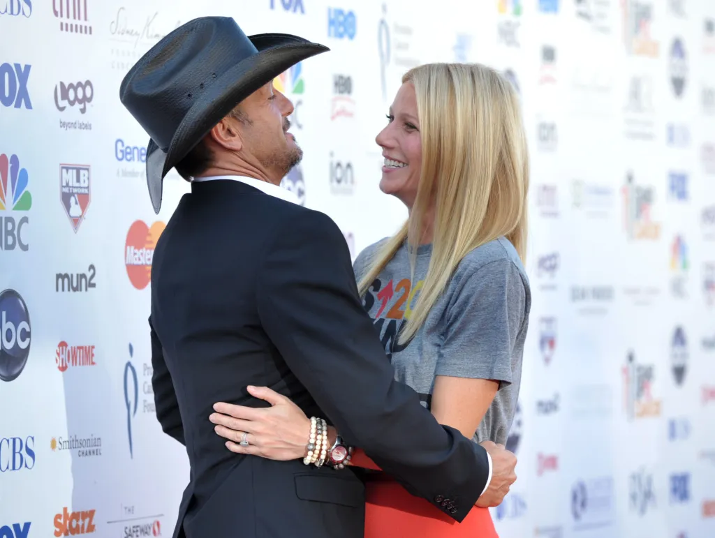 Musician Tim McGraw, left, embraces actress Gwyneth Paltrow at "Stand Up to Cancer" at the Shrine Auditorium on Friday, Sept. 7, 2012 in Los Angeles. The initiative aimed to raise funds to accelerate innovative cancer research by bringing new therapies to patients quickly. McGraw and Paltrow starred as a married couple in the film "Country Strong." Paltrow's father Bruce died from cancer in 2002.