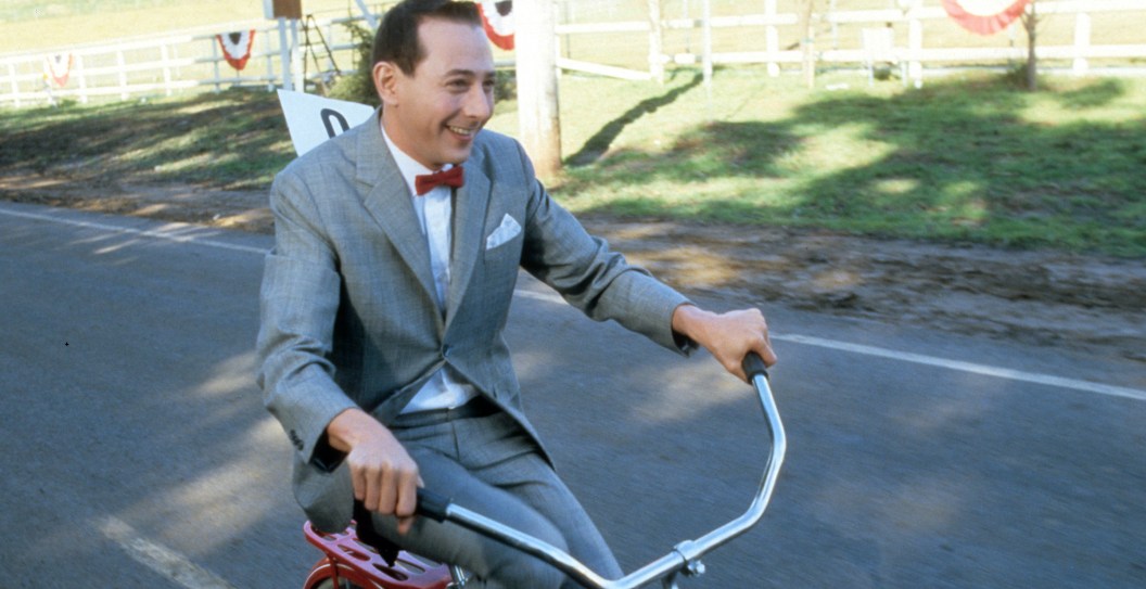 Paul Reubens rides a bike in a scene from the film 'Pee-Wee's Big Adventure', 1985.
