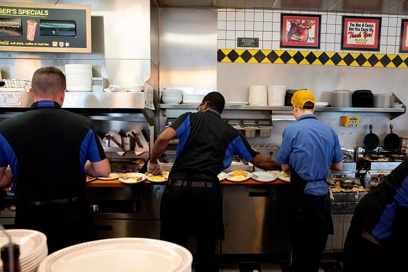 Cooks at Waffle House prepare food at a Waffle House Restaurant on September 13, 2018 in Conway, South Carolina. - Hurricane Florence edged closer to the east coast of the US Thursday, with tropical-force winds and rain already lashing barrier islands just off the North Carolina mainland. The huge storm weakened to a Category 2 hurricane overnight, but forecasters warned that it still packed a dangerous punch, 110 mile-an-hour (175 kph) winds and torrential rains. 
