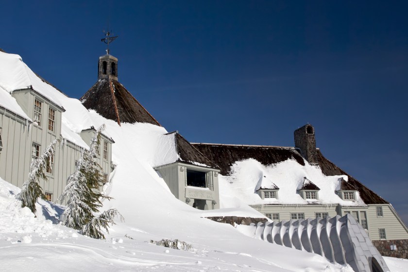 Looking from the side of Timberline Lodge toward the center of building. The entrance area and window to the restaurant are visible. The Lodge is a National Historic Landmark. This is on Mt Hood located in Northwest Oregon.