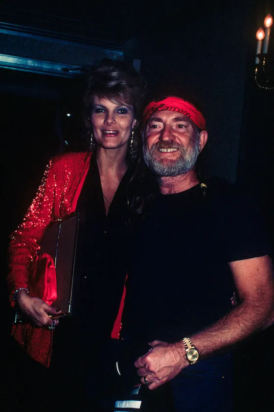 Willie Nelson with his wife Connie Keopke. She is wearing a red sequined jacket; circa 1970; New York.