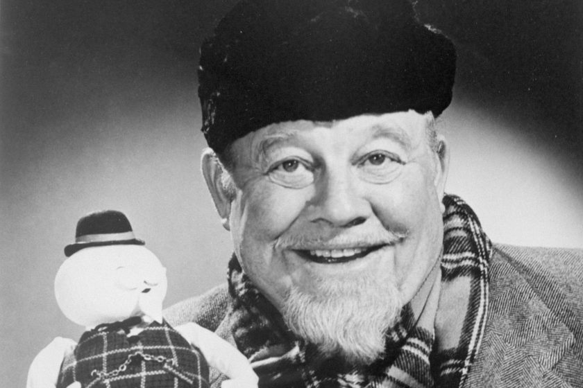 Burl Ives holds up the stop-motion snowman puppet of Sam, whose voice he provides in the TV Christmas special, "Rudolph the Red-Nosed Reindeer".