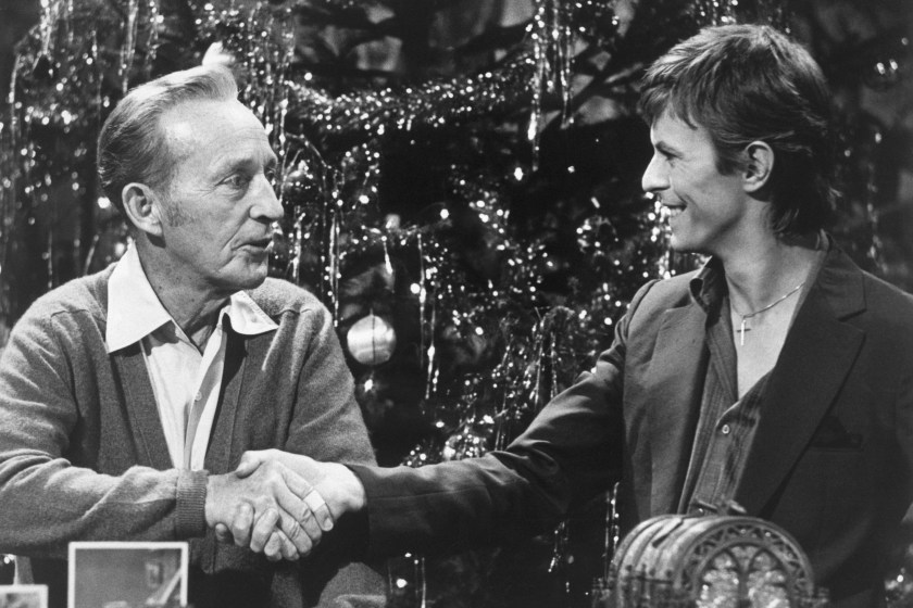 Bing Crosby and David Bowie shake hands during the taping of the television special "Bing Crosby's Merrie Olde Christmas". The two singers, of diverse styles, sang together on "Little Drummer Boy."