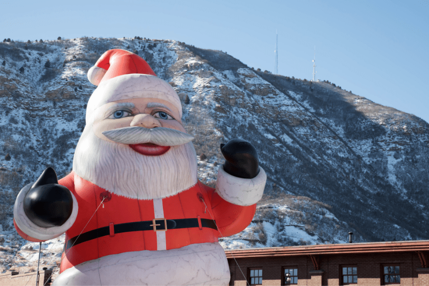 Inflatable Santa Claus in downtown Durango, Colorado with Smelter mountain behind