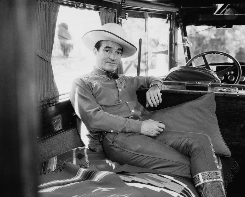 Tom Mix seated in car