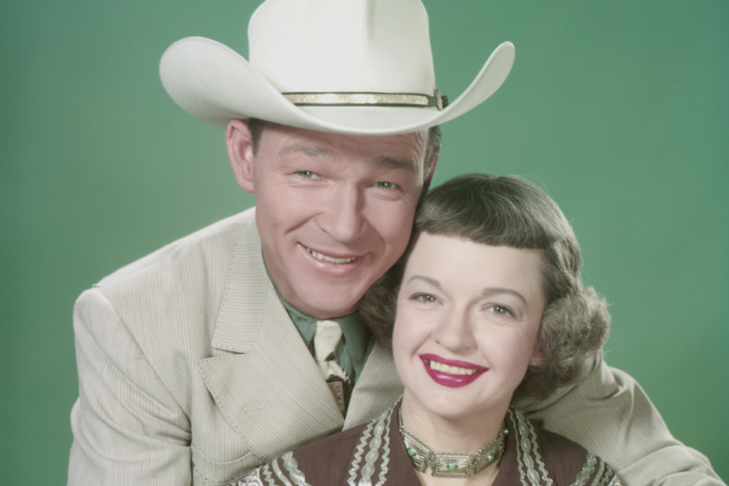 Singer and actor Roy Rogers (1911-1998) and his wife Dale Evans (1912-2001) pictured smiling with Rogers seated behind his wife with his arms around her USA, circa 1955. (Photo by Archive Photos/Getty Images)