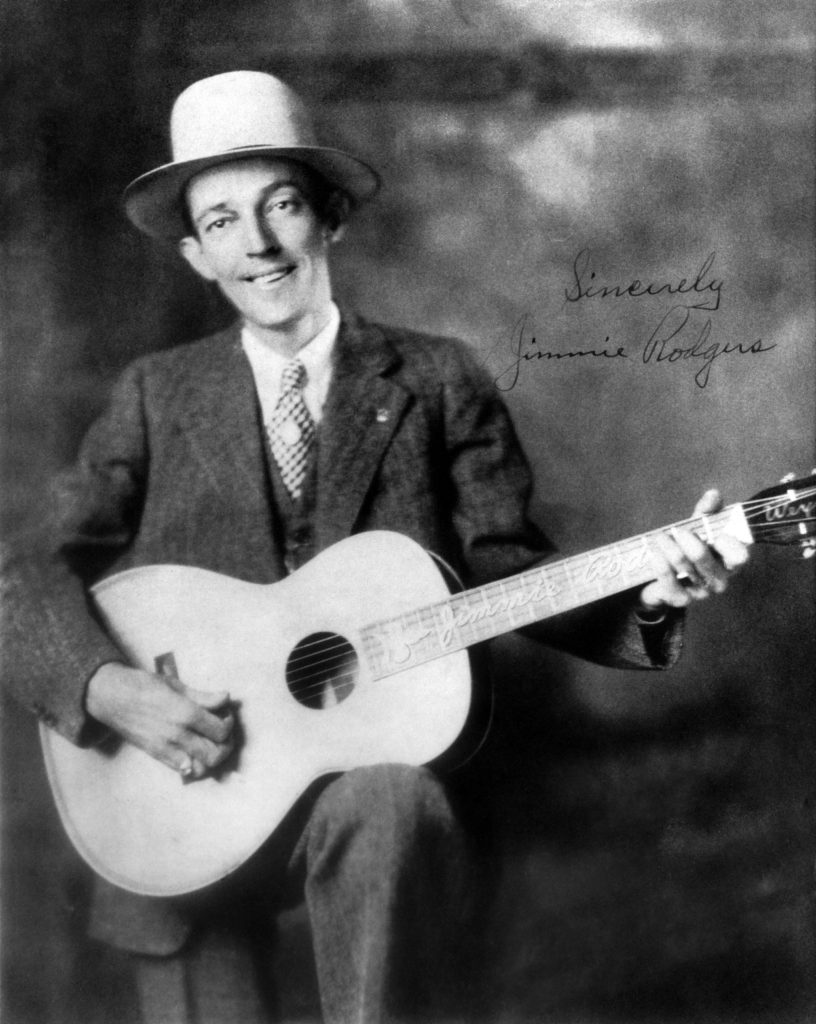 Photo of Country singer Jimmie Rodgers (1897-1933) posed with acoustic guitar circa 1930.