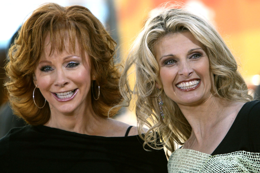 Country singer Reba McEntire poses for a photo with her backup singer Linda Davis during a live performance on NBC's "Today" show in Rockefeller Plaza June 4, 2004 in New York City.