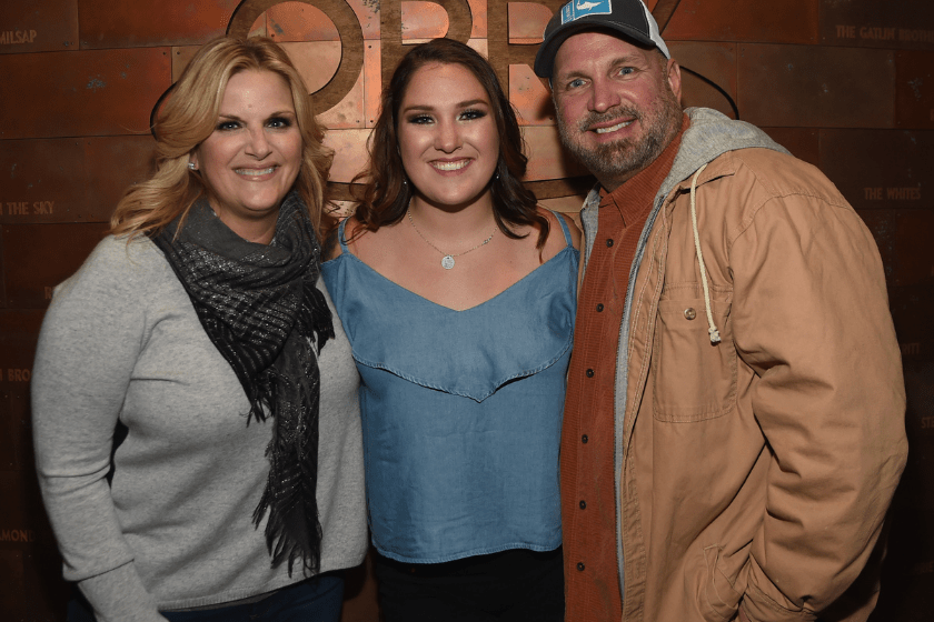 Singer/Songwriter Allie Colleen Brooks (center) Daughter of Garth Brooks and first wife Sandy Brooks poses with her stepmom Singer/Songwriter Trisha Yearwood and dad Singer/Songwriter Garth Brooks after making her Grand Ole Opry debut during Dr. Ralph Stanley Forever: A Special Tribute Concert at Grand Ole Opry House on October 19, 2017 in Nashville, Tennessee