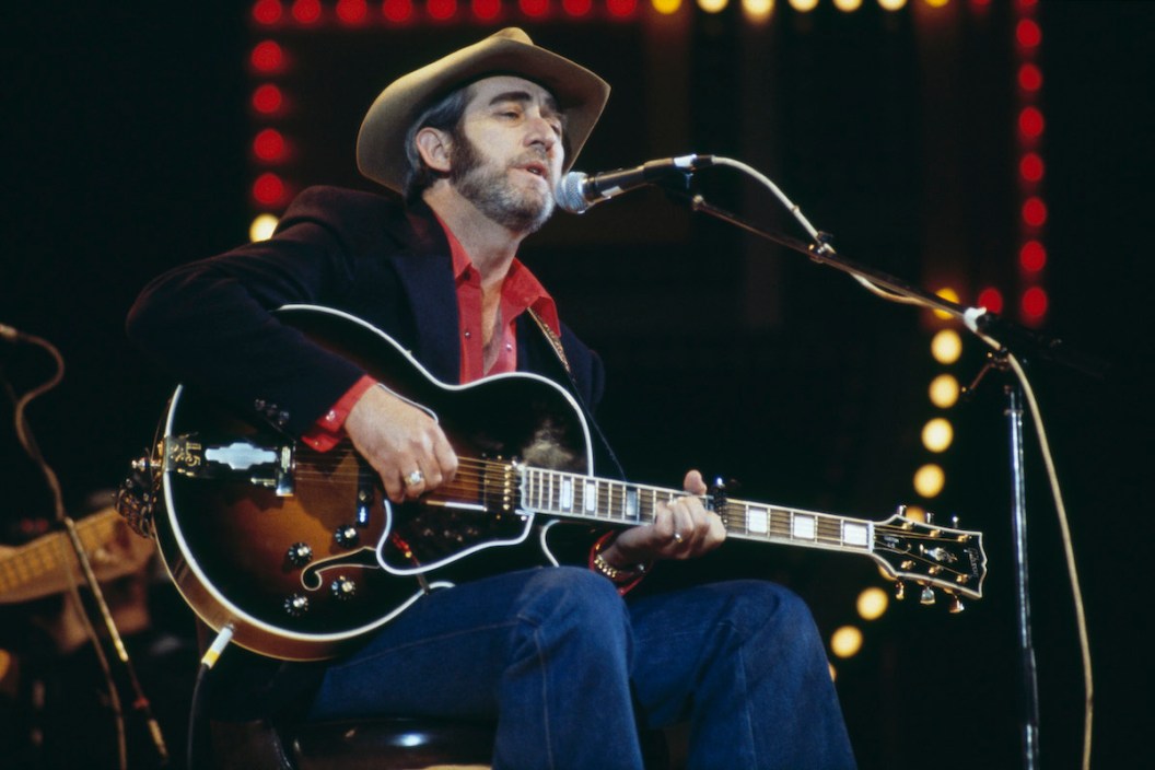 Don Williams, U.S. country music singer-songwriter, playing the guitar and singing into a microphone on stage at the Country Music Festival, at Wembley Arena, London, England, Great Britain, in April 1982.