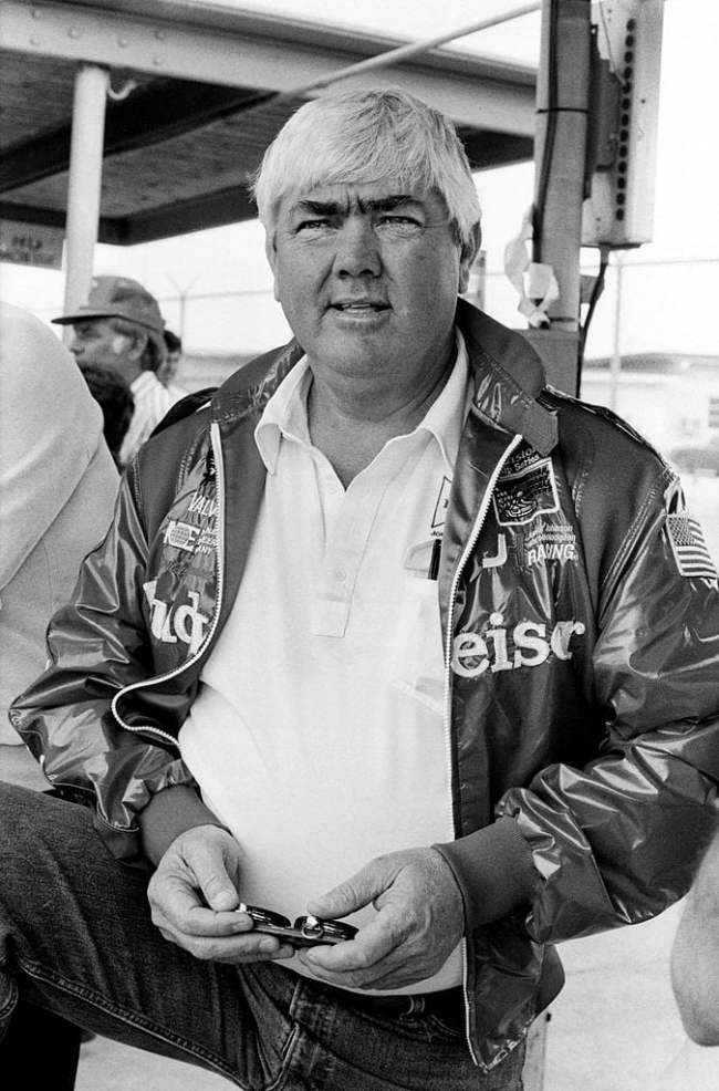 race car owner Junior Johnson uses a stopwatch to check the speeds of cars