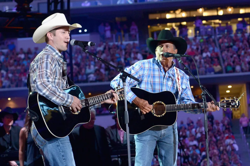 Musician George Strait (R) and his son Bubba Strait perform onstage at George Strait's 'The Cowboy Rides Away Tour' final stop at AT&T Stadium at AT&T Stadium on June 7, 2014 in Arlington, Texas.