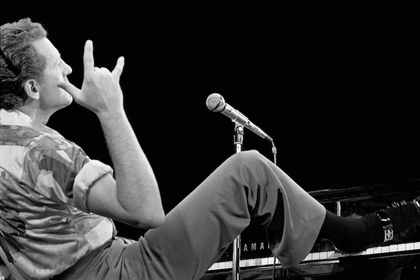 DENMARK - JANUARY 01: Photo of Jerry Lee LEWIS; Performing live onstage, feet up on piano.