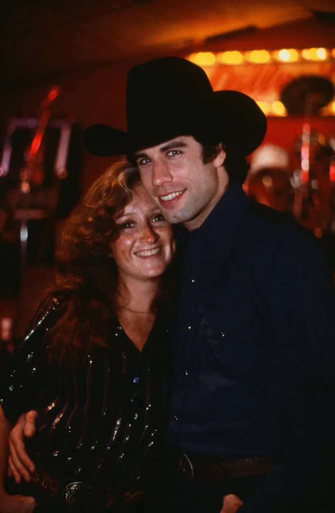 Actor John Travolta with Bonnie Raitt on set during the Paramount Pictures movie 'Urban Cowboy" circa 1980.