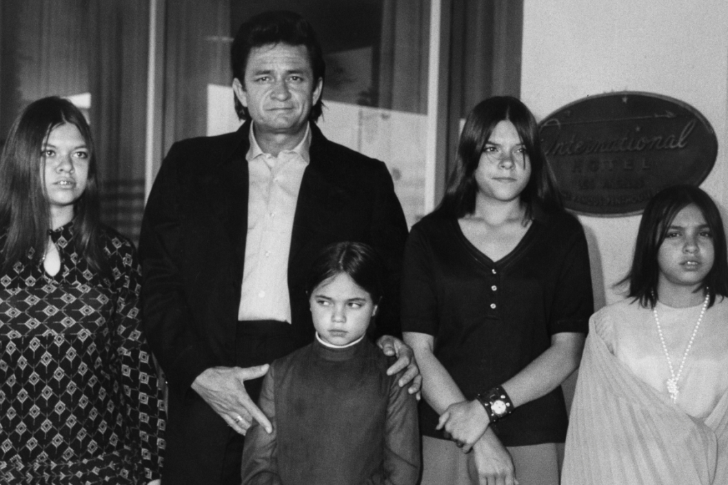 American singer-songwriter Johnny Cash (1932 - 2003) and his four daughters from his first marriage on heir way to a Catholic Mass at the Church of St Anastasia in Inglewood, Los Angeles, May 1970. The girls are (left to right) Kathy, Tara, Rosanne and Cindy. Cash was in town for a concert.