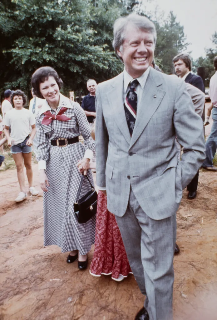 Democratic presidential candidate Jimmy Carter and his wife Rosalynn walk with daughter Amy (partially hidden) as they spend the July 4th holiday weekend at the family home in Plains, Georgia, July 9th 1976. (