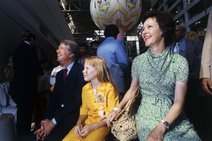 Atlanta: Jimmy Carter, Wife, and daughter Amy watch a puppet show at an Atlanta amusement complex 6/8. Primary wins push Carter close to the Democratic presidential nomination.