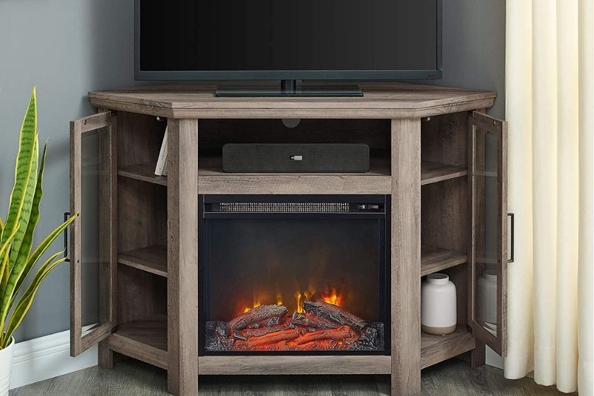 light brown corner electric fireplace with tv on top of base