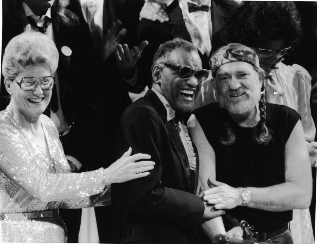 L-R: American musicians Minnie Pearl, Ray Charles and Willie Nelson smile together at an unidentified event, 1980s. (Photo by Hulton Archive/Getty Images)