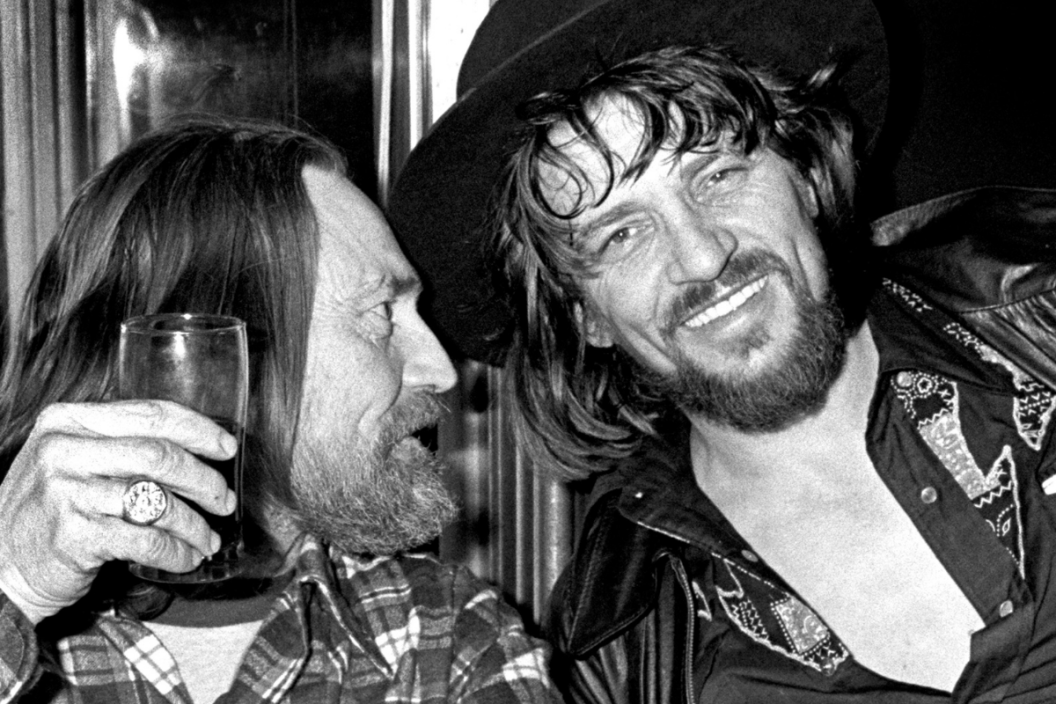 Willie Nelson and Waylon Jennings enjoy a drink together in New York in 1978