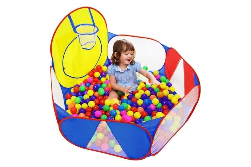 child having fun in a ball pit for toddlers
