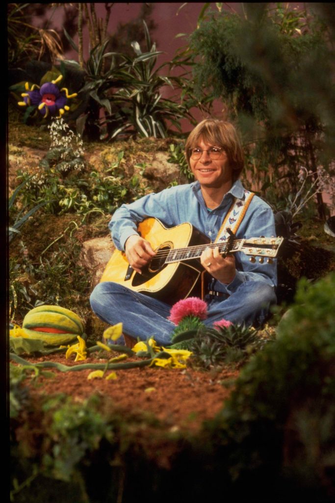 Country musician John Denver performing on the set of The Muppet Show at Elstree Studios, Hertfordshire, circa 1979.