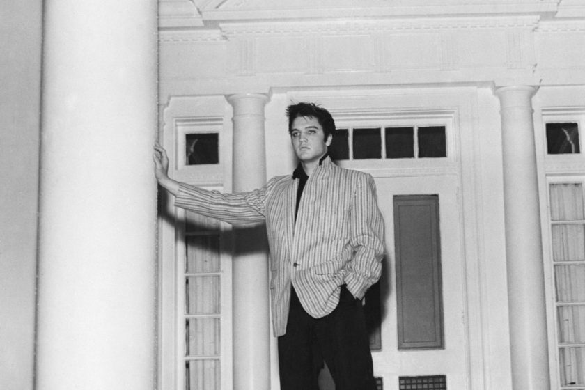 (Original Caption) 3/26/1957-Memphis, TN-A thoughtful Elvis Presley leans against a massive pillar on the front porch of his traditional southern-style home, "Graceland," at Whitehaven, near Memphis.