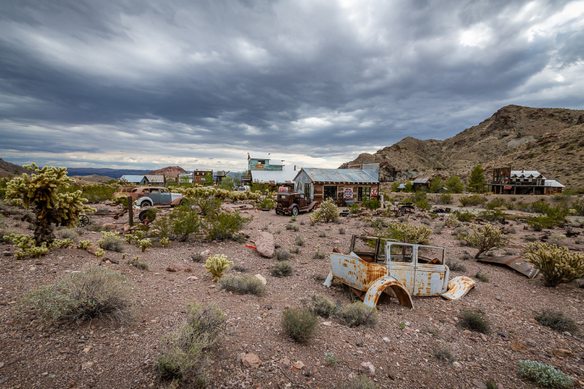 The vintage vehicles, weathered buildings, and eclectic billboards that are displayed in the town of Nelson, Nevada.
