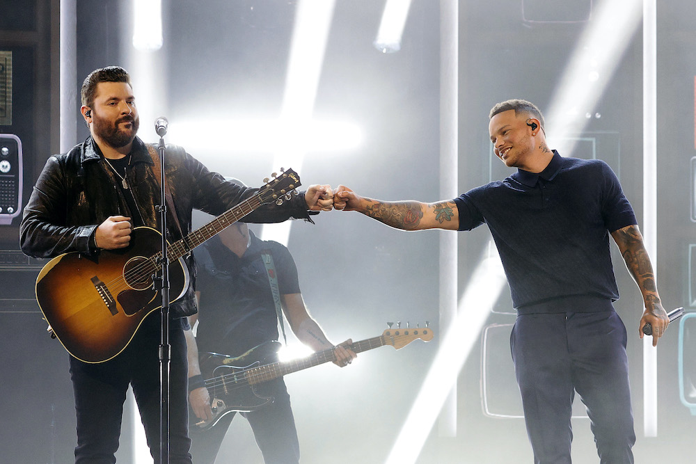 Chris Young and Kane Brown fist bump during an ACM Awards performance.