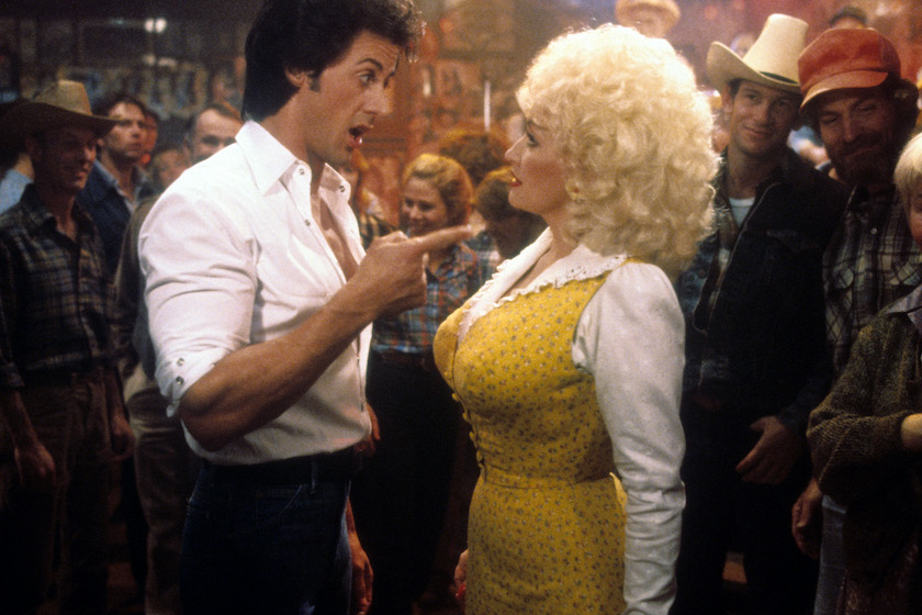 Sylvester Stallone points to Dolly Parton in a scene from the film 'Rhinestone', 1984. 