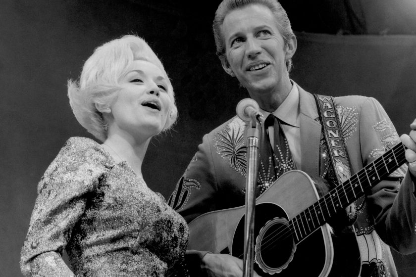 Country singers Dolly Parton and Porter Wagoner perform onstage in circa 1967 in Nashville, TN. Mr. Wagoner is wearing a Nudie suit desgned by Nudie Cohn of Nudie's Rodeo Tailors.