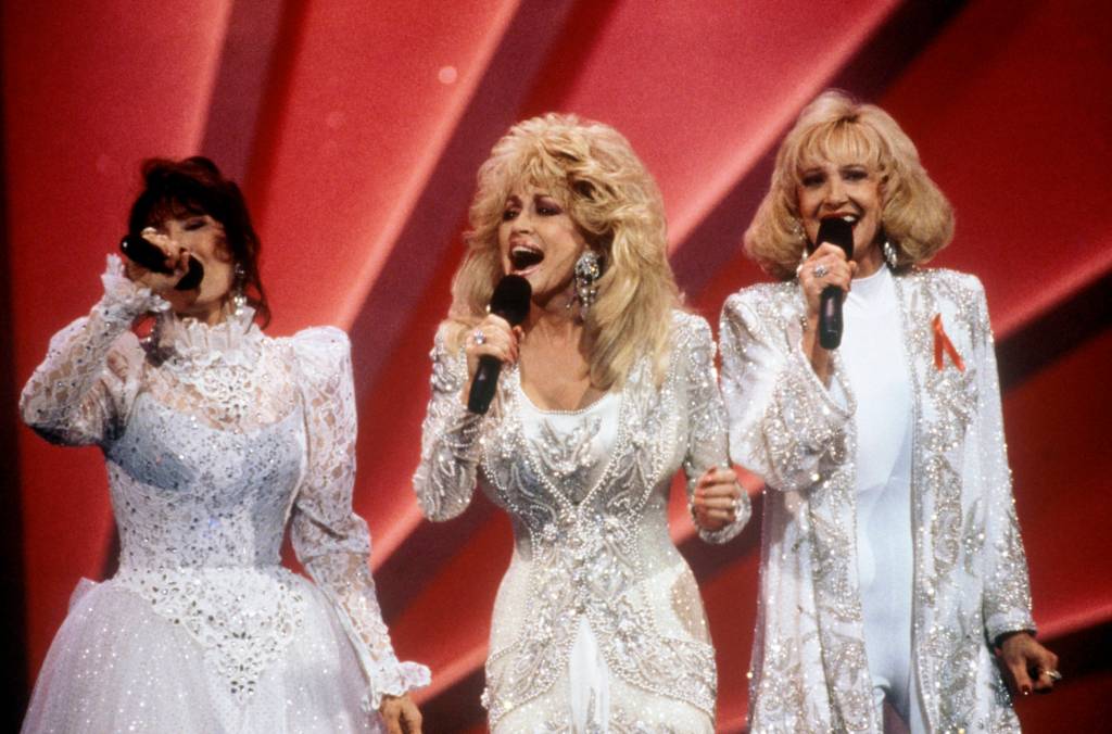 Photo of Tammy Wynette, Loretta Lynn and Dolly Parton performing together