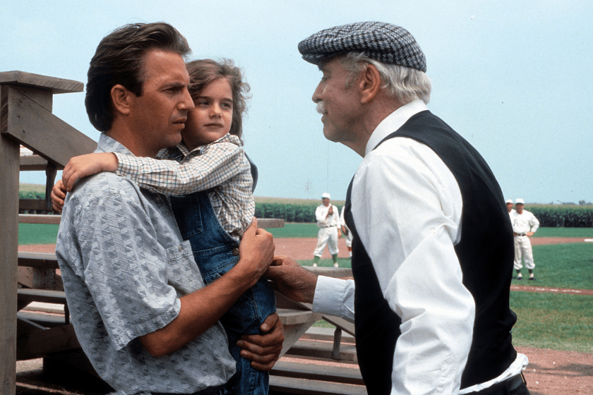 Kevin Costner holding Gaby Hoffmann in a scene from the film 'Field Of Dreams', 1989