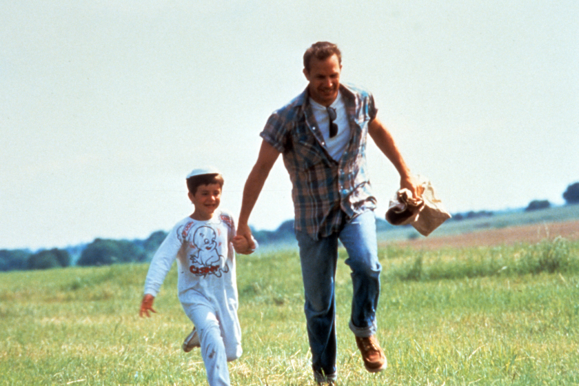 Kevin Costner holds onto a child in a scene from the film 'A Perfect World', 1993