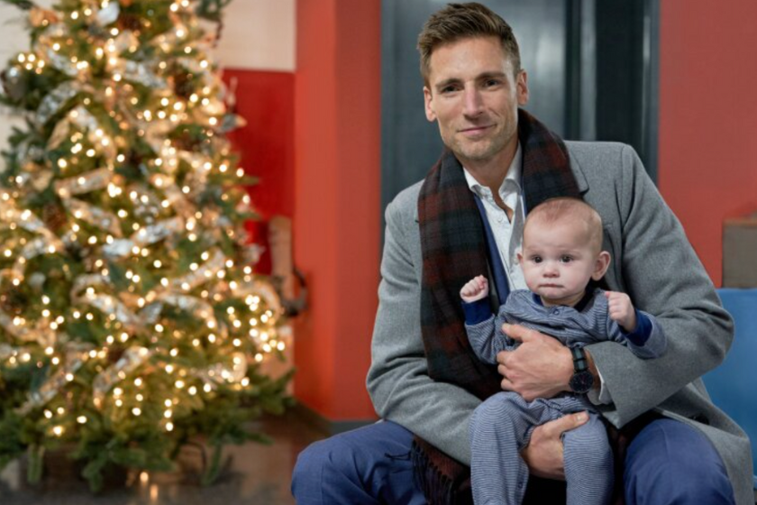 Andrew Walker poses with baby for Hallmark movie 'Three Wise Men and a Baby"