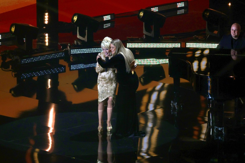 LAS VEGAS, NEVADA - MARCH 07: (L-R) Dolly Parton and Kelly Clarkson speak onstage during the 57th Academy of Country Music Awards at Allegiant Stadium on March 07, 2022 in Las Vegas, Nevada. (Photo by Jason Kempin/Getty Images for ACM)