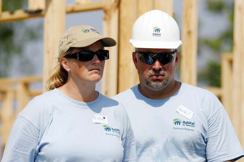 Country singers Trisha Yearwood (L) and her husband Garth Brooks listen to former U.S. President Jimmy Carter speak after raising the wall on the 1,000th and 1,001st homes to be built by Habitat for Humanity on the Gulf Coast May 21, 2007 in Violet, Louisiana. Carter made waves May 19 when he said that the Bush administration "has been the worst in history", in an interview published in the Arkansas Democrat-Gazette. 