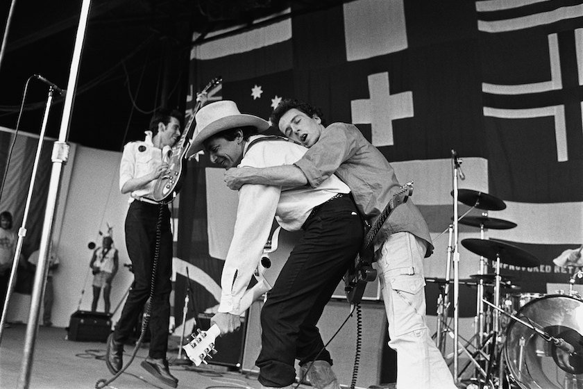 Joe Strummer, guitarist for the British punk rock band The Clash, hangs onto country singer Joe Ely during a performance at a 1979 Monterey, California, concert dubbed "Monterey Pop Festival II." 