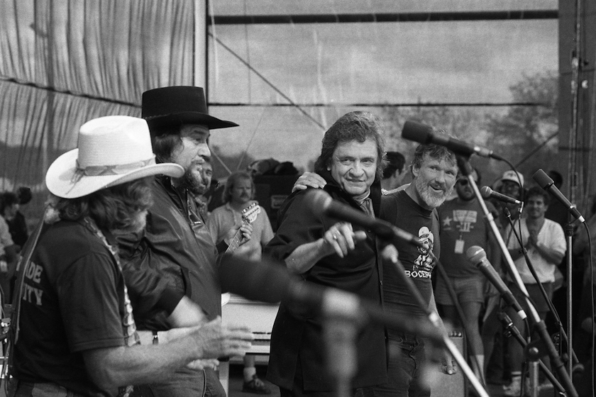 Country singer and songwriter Willie Nelson, Waylon Jennings, Johnny Cash, and Kris Kristofferson perform as the Highwaymen at Willie Nelson Fourth of July picnic on July 4, 1985 in Austin, Texas.