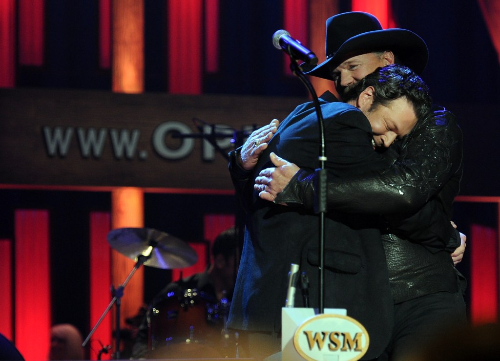 Recording Artist Blake Shelton just after Recording Artist Trace Adkins (in hat) suprises him with an invite from the Opry to become a member of The Opry during Country Comes Home: An Opry Celebration at the Grand Ole Opry House on September 28, 2010 in Nashville, Tennessee. The Grand Ole Opry House has been restored following damage sustained during flooding in May 2010.